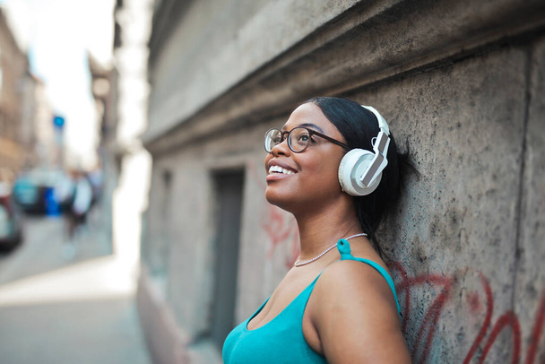 portrait of young woman while listening to music - Foto, immagini