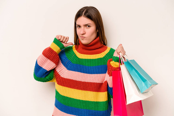 Young caucasian woman going to shopping isolated on white background feels proud and self confident, example to follow. - Foto, imagen