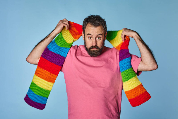 portrait gay man with rainbow colored scarf. Gay pride day. lgbq community. - Fotoğraf, Görsel