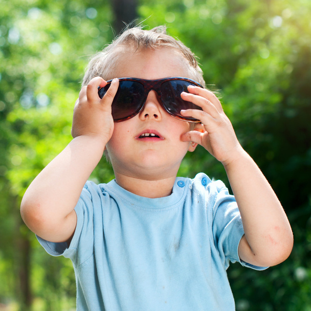 Boy Sunglasses in the summer park - 写真・画像