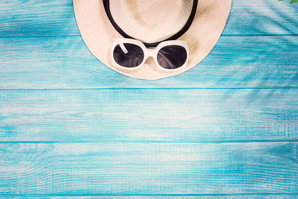 Top view of summer beach accessories on marine blue planks - 写真・画像