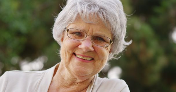 Mature woman smiling and looking at camera - Photo, Image