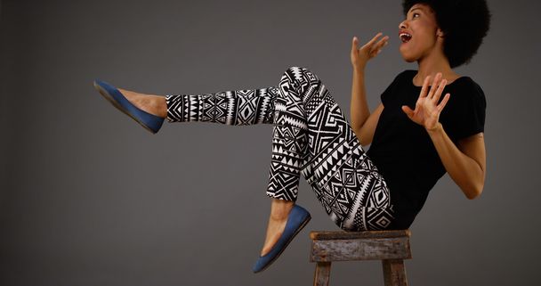 Black woman dancing on chair - Foto, Imagem