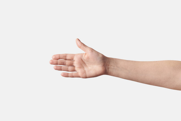 Female wide open, hand to elbow reaching for a handshake with a thumb up, isolated on white background. - Фото, зображення