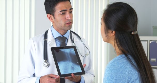 Mexican doctor talking with Chinese patient about xray - Photo, Image