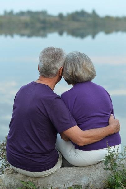 Mature couple sitting near lake - Foto, immagini