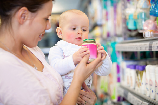 Mother with Baby in Supermarket - Photo, Image