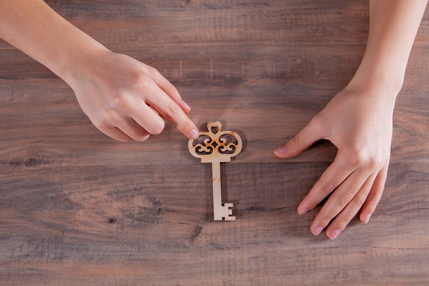 young girl holding wooden keys - Fotoğraf, Görsel