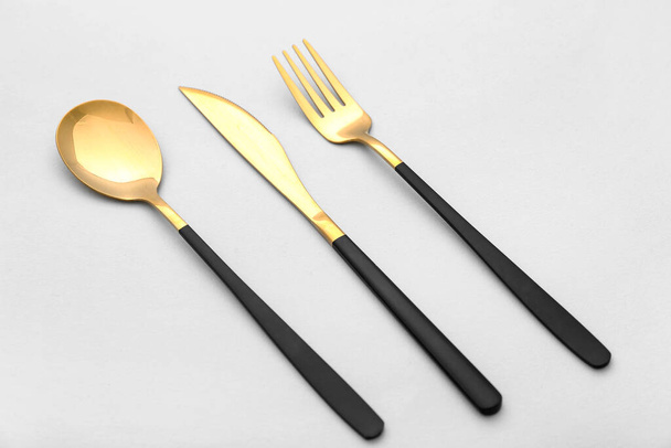 Set of stainless steel cutlery with black handle on white background - Foto, imagen