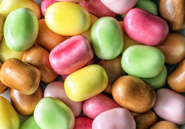 a close-up of a bunch of chewing candies of different colors with a sparkling filling, top view - Photo, Image