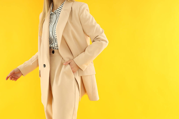 Young business woman on yellow background, space for text - Fotó, kép