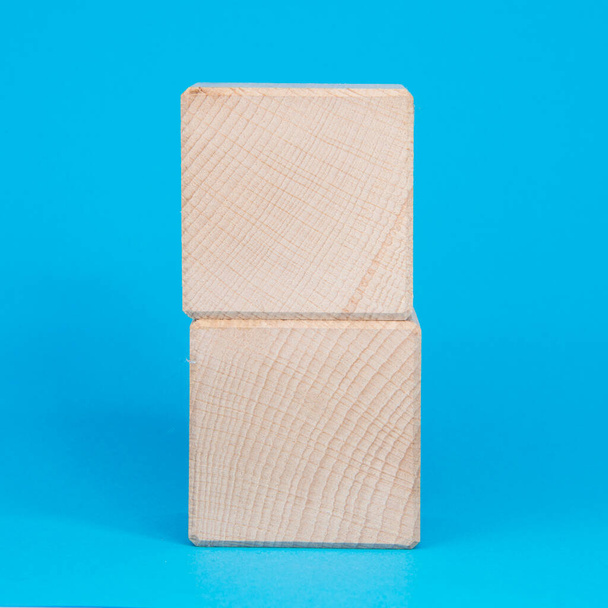 Empty clear wooden cube on blue background - Photo, Image