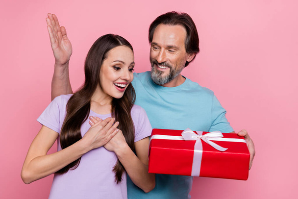 Photo of two idyllic lovely people man give giftbox excited amazed lady isolated on pink color background - Fotografie, Obrázek
