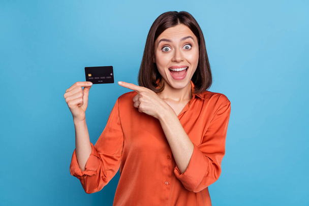 Portrait of attractive crazy cheerful girl demonstrating bank card freelance currency isolated over bright blue color background - Φωτογραφία, εικόνα