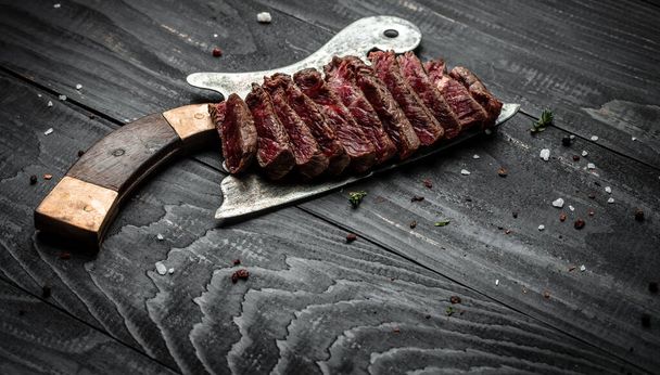 Barbecue dry aged wagyu porterhouse steak, grilled medium rare beef steak with spices served on old meat butcher. sliced. Long banner format, top view. - Photo, Image