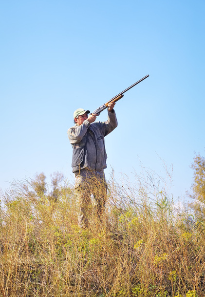 Hunter taking aim at the target. Hunter with a gun.  - Photo, Image