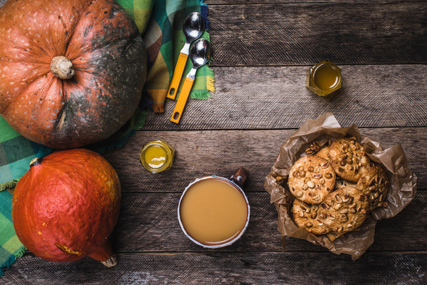 Pumpkins, soup, honey and cookies with nuts on wood. Autumn Season food photo - Foto, afbeelding