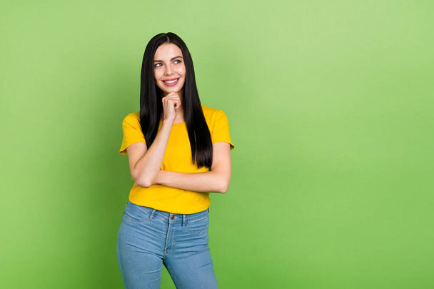 Photo of charming thoughtful lady dressed yellow t-shirt arm chin looking empty space isolated green color background. - Valokuva, kuva