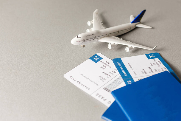 パスポート付きの航空券、飛行機のモデル、白い背景に隔離された. - 写真・画像