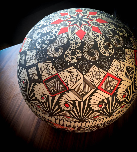 Photograph of a Hand painted ceramic sphere with abstract symbols - Fotó, kép