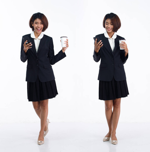 Full length 20s young Asian Business Woman accountant financial wear blazer skirt, looking at work. Office female carry cell phone coffee cup happy smile over white background isolated - Foto, imagen
