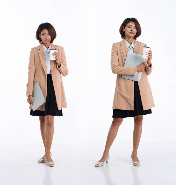 フル長さ20代の若いアジアのビジネス女性はブレザースカートを着用してください。オフィス女性は白い背景に幸せな笑顔ノートパソコンのコーヒーカップを運ぶ孤立 - 写真・画像