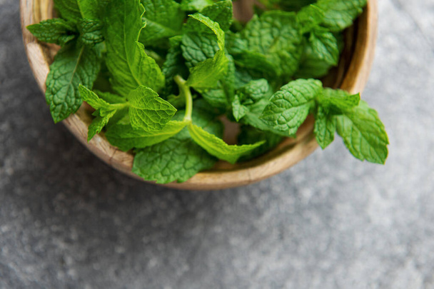 Close view of fresh mint leaves on a dark concrete background - Photo, Image