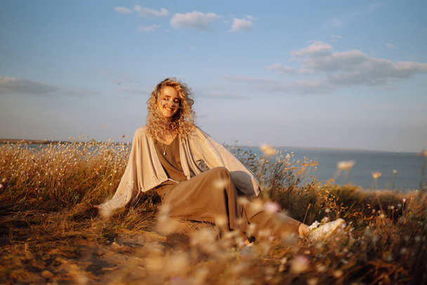 Young woman resting in nature. People, lifestyle, relaxation and vacations concept. Fashion, style concept. - Фото, зображення