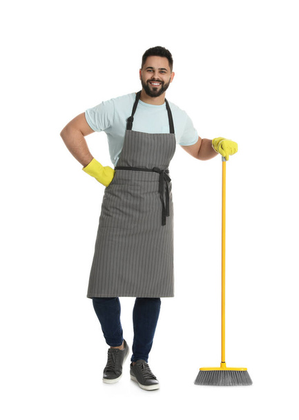 Young man with yellow broom on white background - Foto, immagini
