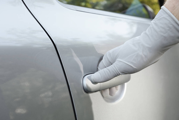 Closeup view of man in glove opening car door - Foto, afbeelding
