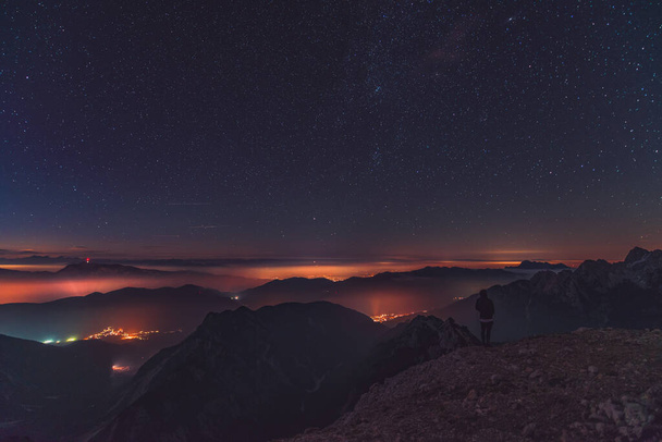 Sunset and stars at dusk in Julian alps mountain range. Serenity and friendship in the mountains. - 写真・画像