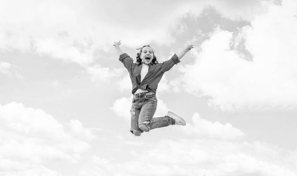 cheerful child jump in casual denim apparel outdoor, happiness. - Zdjęcie, obraz
