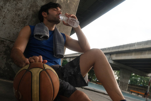 Young causian basketball player resting and ralax.  - Foto, Imagen