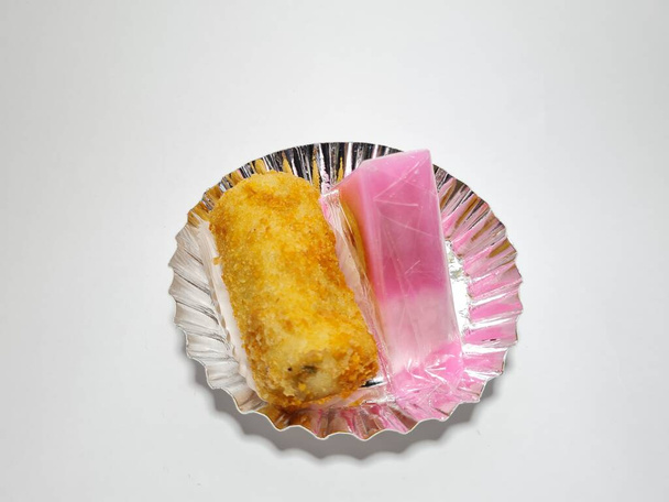 Cake in a container, namely pudding cake and chicken filling on a white background - Photo, Image