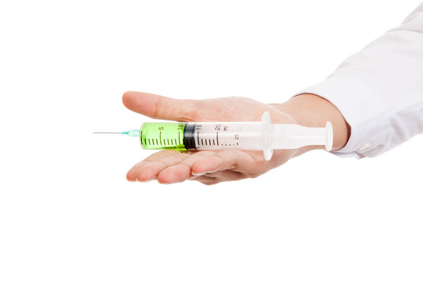 Close up of syringe with green medicine on palm hand - Foto, Imagem