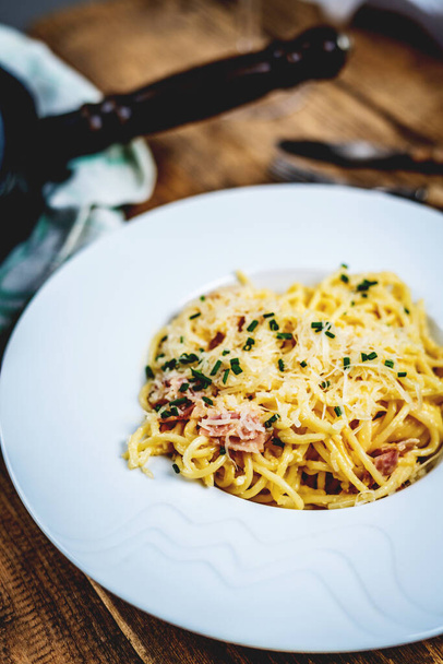Italian cuisine pasta spaghetti ala carbora with egg, cheese parmasan and bacon - Photo, Image