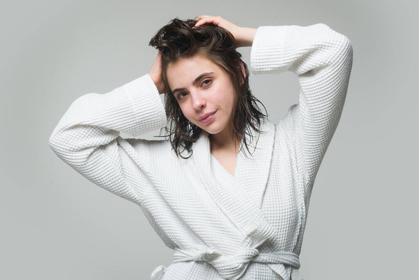 Young woman portrait in bathrobe. Morning female model with wet hair. Beauty morning routine - Foto, imagen