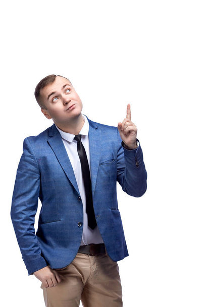 Young handsome business man looking and pointing index finger to the up while isolated on white background - Foto, Bild