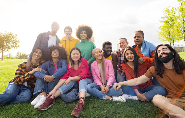 large group of diverse multiracial young people in the park, celebrating life together enjoying happy holidays. lifestyle, travel, togetherness and joy concept - Photo, Image