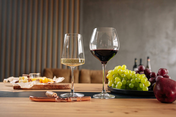 Assorted wine glasses with appetizers on wooden table - Foto, imagen