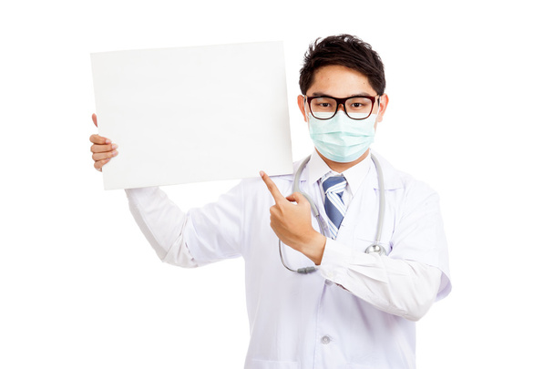 Asian male doctor wear mask point to blank banner - Zdjęcie, obraz