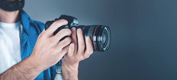 photographer hand camera on gray background - Fotó, kép