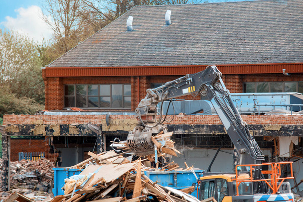 Demolition of building. Excavator breaks old house. Making space for the construction of a new houses - Photo, Image