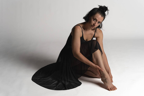studio photo. Studio shot of a young woman dancer with black body dancing - Photo, Image