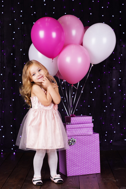 Petite fille avec des ballons roses et des boîtes cadeaux
 - Photo, image