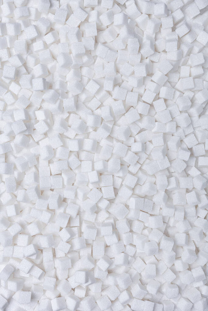 Rafinated sugar. Textured white background from sugar cubes. Light back. - Foto, afbeelding