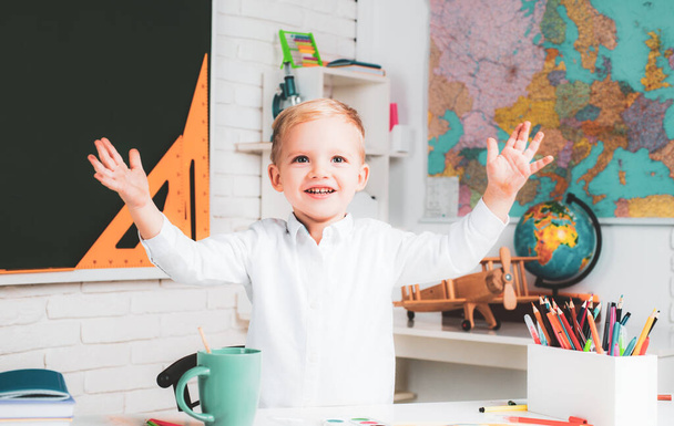 Education. Portrait of Pupil in classroom. Kids from primary school. Little ready to study. School interiors. Cute pupil with funny face schooling work - Foto, Bild
