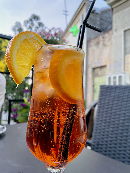 Aperol spritz with orange slice at outside cafe Aperol is an Italian aperitif made of herbs and soda - Photo, Image
