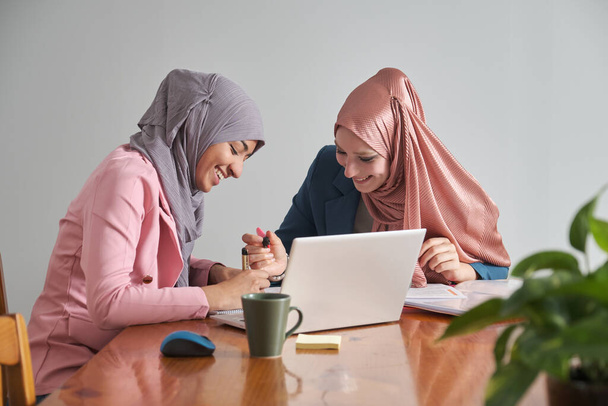 Two muslim female university students wearing hijab studying after class. Morocco college students. - Photo, image