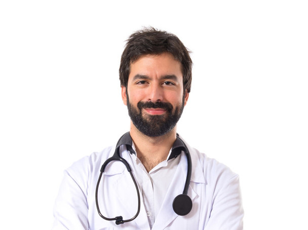 Doctor with his arms crossed over white background - Fotoğraf, Görsel